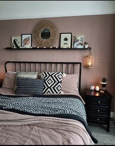 a bed room with a neatly made bed and some pictures on the wall above it