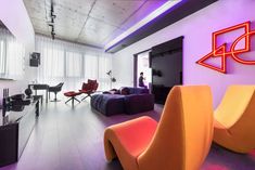 a living room filled with purple and orange furniture