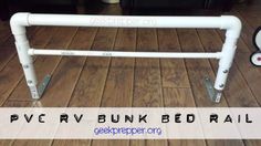 an image of a bed rail made out of plastic pipes and pipe holders on the floor