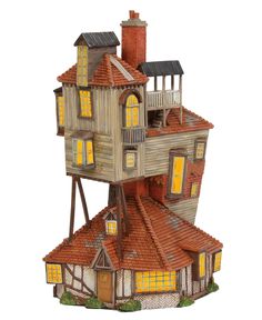 a toy house that is made out of wood and has windows on the top floor