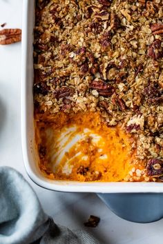 a casserole dish with carrots and granola in it on a table