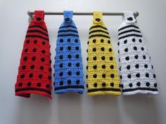 four crocheted neckties hanging on a clothes line, all in different colors