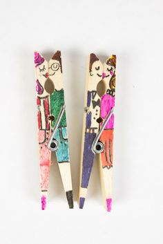 two wooden pegs that have been decorated with children's drawings and pencils