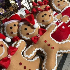 some very cute looking gingerbreads with hats and bows on their heads for sale