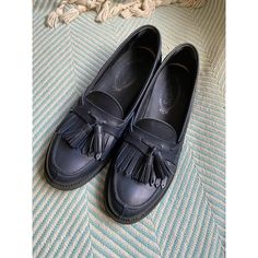 Classic Slip-On Leather Loafers. Fringed Tassel Detail On The Vamps With Small Embossed T Logo. Leather Lined Insoles. Signature Tod’s Rubber Soles. Approximate 1” Heel Height. Great Condition With Small Scuffs At Right Front Toe, Right Side, And Right Heel As Seen In Photos. Small Water Mark On Left Tongue/Top Of Vamp Area. Visible Wear To Insole At Heels. T Logo, Tods Shoes, Water Mark, Tassel Fringe, Leather Tassel, The Vamps, Leather Loafers, Blue Leather, Loafer Flats