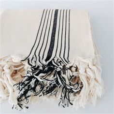 a black and white striped blanket laying on top of a table