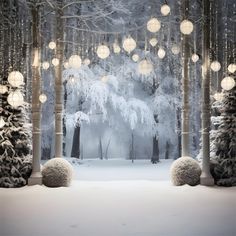 a snowy scene with lights hanging from the trees and balls on the snow covered ground