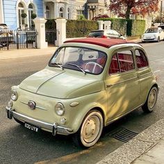 an old car is parked on the side of the street