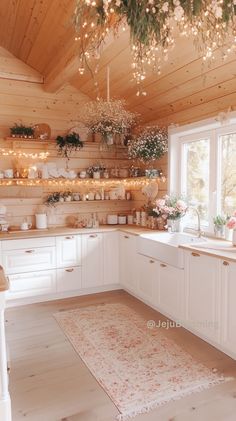 a kitchen filled with lots of white cabinets and counter top space next to a window