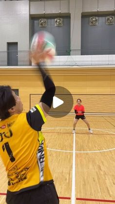 two people on a court with a ball in the air