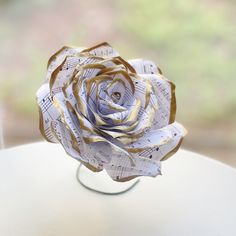 a paper rose sitting on top of a table