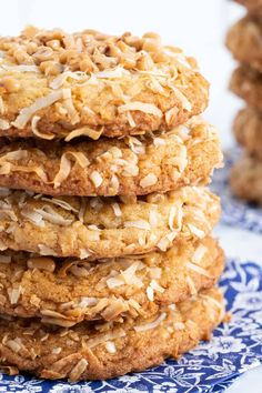 a stack of cookies sitting on top of a blue and white plate with coconut flakes