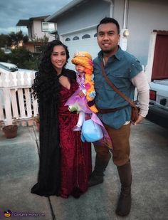 a man standing next to a woman in a costume