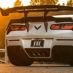 the rear end of a white sports car