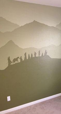 a wall painted with the nativity scene of jesus and his family on top of a hill