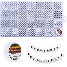 the words you are beautiful spelled out in white letters on a plastic mat and two spools of beads