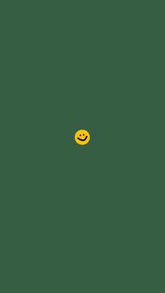 a yellow smiley face on a green background