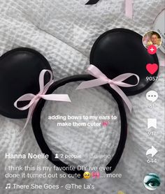 a minnie mouse ears with pink ribbon on it