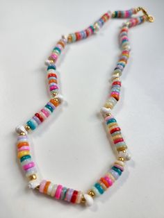 Handmade 14" beaded necklace complete with tiny seashells! Gold plated findings and clasp. Adjustable Shell Beaded Necklace With Colorful Beads, Multicolor Beaded Strand Shell Necklace, Colorful Shell Necklaces With Round Beads, Handmade Multicolor Strand Shell Necklace, Multicolor Shell Strand Necklace, Multicolor Shell Beaded Necklaces With Round Beads, Multicolor Beaded Shell Necklace Strand, Multicolor Shell Beaded Necklaces, Multicolor Round Bead Shell Necklace