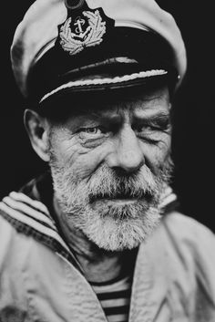 black and white photograph of an old man wearing a sailor's hat, looking at the camera