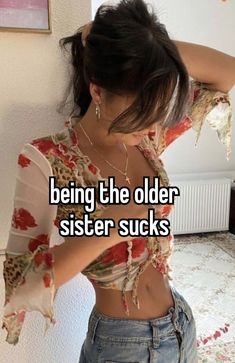 a woman with her arms behind her head and the words being the older sister sucks