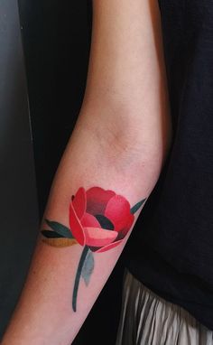 a person with a rose tattoo on their arm