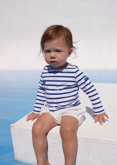 Easy to mix and match, this long-sleeve striped sailor shirt lends itself to a multitude of styles to brighten a child's day: Blue and white for little sailors, with a tulle skirt for dancing princesses, worn even with the motley colors of a clown costume....the possibilities are endless. For a Grown-Up-&-Me look, coordinates with our best-selling MINQUIERS MODERNE. Made in Saint-James, Normandy, France. 100% lightweight cotton jersey. Striped Sailor Long Sleeve Top, Sailor Style Striped Long Sleeve Top, Sailor Striped Long Sleeve Top, Playful Striped Long Sleeve Top, Striped Long Sleeve Playful Top, White Marine Style Long Sleeve Top, White Sailor Style Long Sleeve Tops, Nautical Style Long Sleeve Summer Tops, Nautical Long Sleeve Tops For Summer