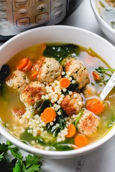 two bowls of soup with meatballs, carrots and couscous in front of an instant pressure cooker