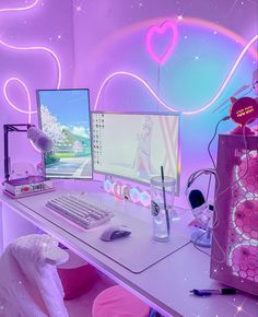 two computer monitors sitting on top of a desk next to a pink bag and other items