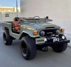 an army jeep parked in front of a building