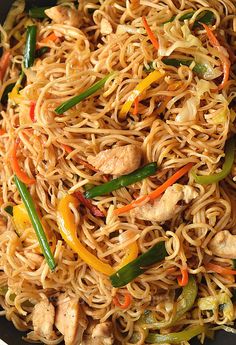 a skillet filled with noodles and chicken