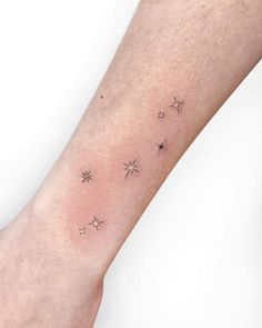 a person's arm with small stars on it