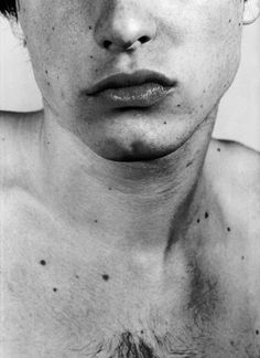 a shirtless man with freckles on his chest