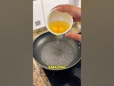 someone is pouring eggs into a pan on the stove