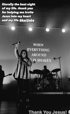 a woman standing on top of a stage holding a microphone