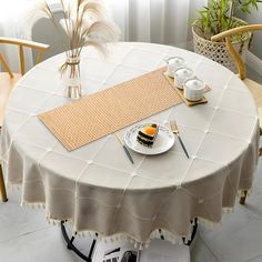 a table with a place setting on top of it and two chairs next to it