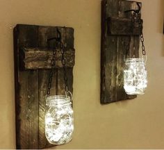 two mason jars are hanging on the wall