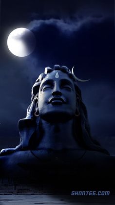 a statue with the moon in the sky behind it and an image of a man's head