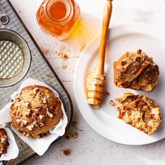 muffins and honey on a plate next to a cupcake pan with some butter