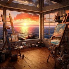 an artist's studio with the sun setting over the ocean