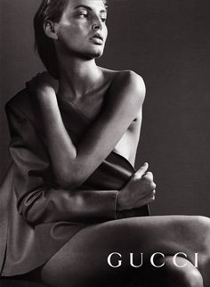 a black and white photo of a woman sitting on the ground