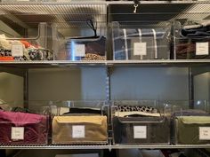 several clear bins with labels on them in a closet