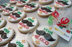 decorated cookies in the shape of mustaches are on display