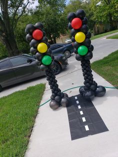 some balloons are standing in the middle of a sidewalk