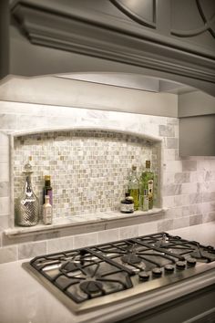 a stove top oven sitting inside of a kitchen next to a wall mounted range hood