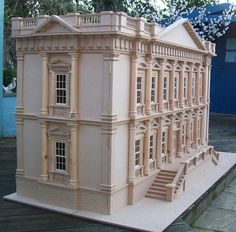 a model of a large building with steps leading up to the front door and windows