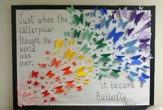 a bulletin board with colorful paper butterflies on it and a quote written in the middle