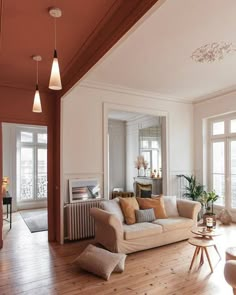 a living room filled with furniture and lots of windows