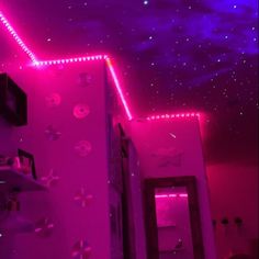 a room with purple lights and stars on the ceiling