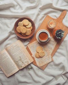 an open book and some cookies on a table